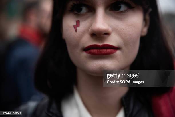 The red lightning bolt that became the symbol of the women's strike seen on a protesters face. Exactly two years ago, the Constitutional Court in...