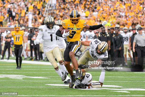 Missouri Tigers wide receiver Luther Burden III slips through the tackle attempt of Vanderbilt Commodores defensive lineman Elijah McAllister ,...