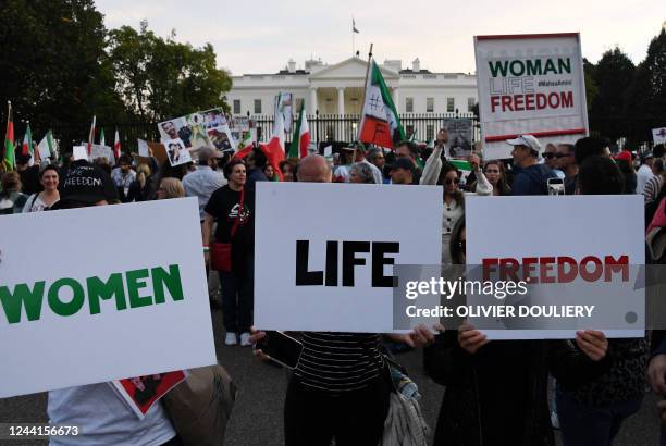 Protesters march in solidarity with protesters in Iran in front of the White House in Washington, DC, on October 22, 2022. - Iran has been rocked by...