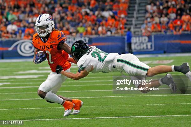 Wide receiver Joshua Cephus of the UTSA Roadrunners avoids the tackle from Sean-Thomas Faulkner of the North Texas Mean Greenin the second half at...