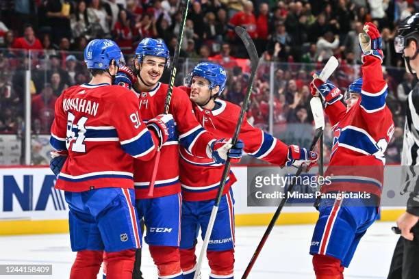Arber Xhekaj of the Montreal Canadiens celebrates his first career NHL goal with teammates Sean Monahan, Chris Wideman and Cole Caufield of the...
