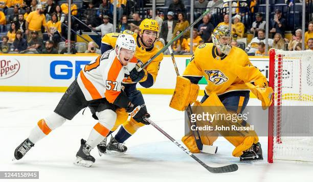 Wade Allison of the Philadelphia Flyers battles in front of the net against Dante Fabbro and Juuse Saros of the Nashville Predators during an NHL...