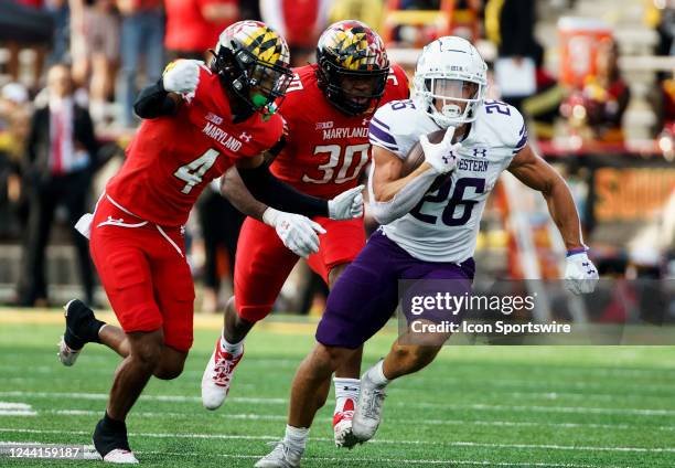 Maryland Terrapins defensive back Tarheeb Still and defensive back Caleb Atogho chase down Northwestern Wildcats running back Evan Hull during a...