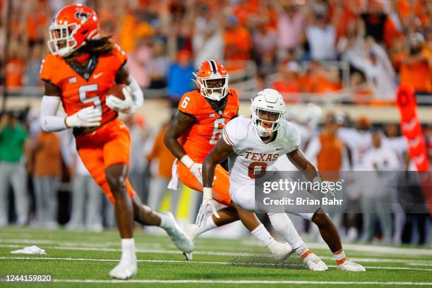 Safety Kendal Daniels of the Oklahoma State Cowboys grabs a deflected pass intended for tight end Ja'Tavion Sanders of the Texas Longhorns for an...