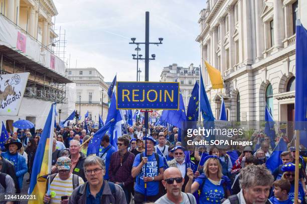 Protester marches with a "Rejoin" placard during the demonstration in Pall Mall. Thousands of people marched through Central London demanding that...