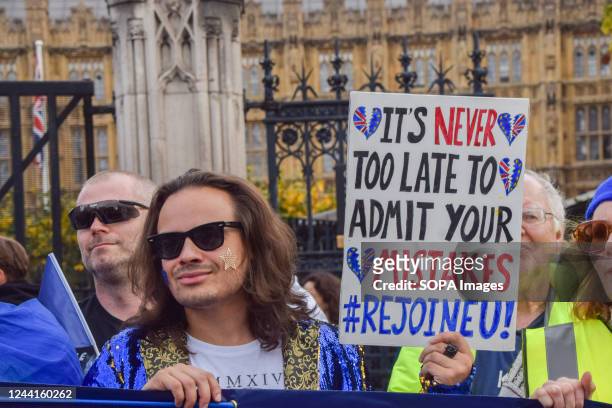 Protester holds a placard which states "It's never too late to admit your mistakes, rejoin EU" during the demonstration in Parliament Square....