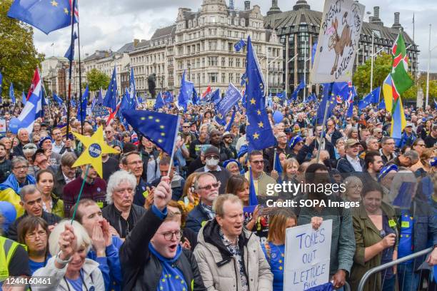 Protesters hold EU flags during the demonstration in Parliament Square. Thousands of people marched through Central London demanding that the UK...