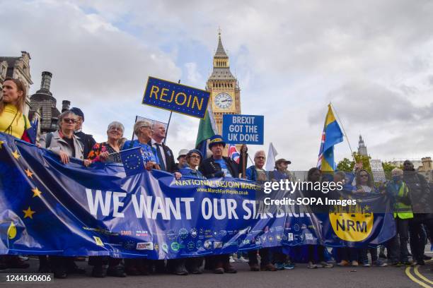 Anti-Brexit activist Steve Bray and fellow protesters hold anti-Brexit placards and a pro-EU banner in Parliament Square. Thousands of people marched...