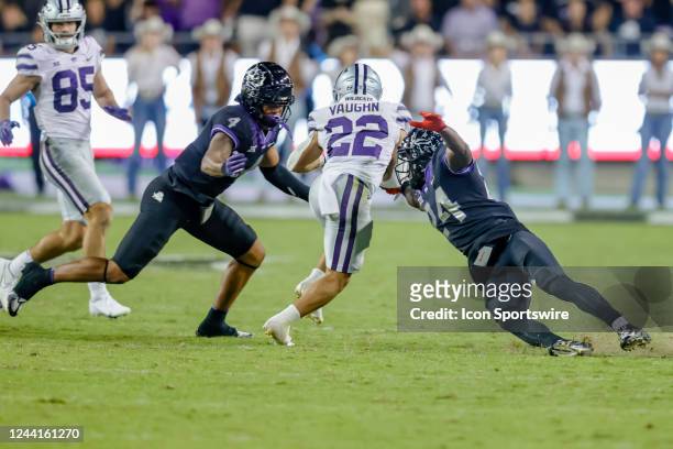 Kansas State Wildcats running back Deuce Vaughn tries to run through the line of scrimmage as TCU Horned Frogs cornerback Josh Newton and safety...
