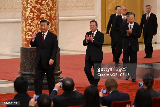 China's President Xi Jinping walks with members of the Chinese Communist Party's new Politburo Standing Committee, the nation's top decision-making...