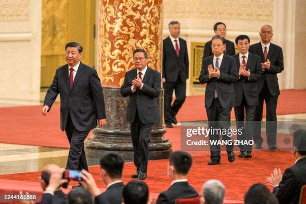 China's President Xi Jinping walks with Li Qiang, Li Xi, Zhao Leji, Ding Xuexiang, Wang Huning and Cai Qi, members of the Chinese Communist Party's...