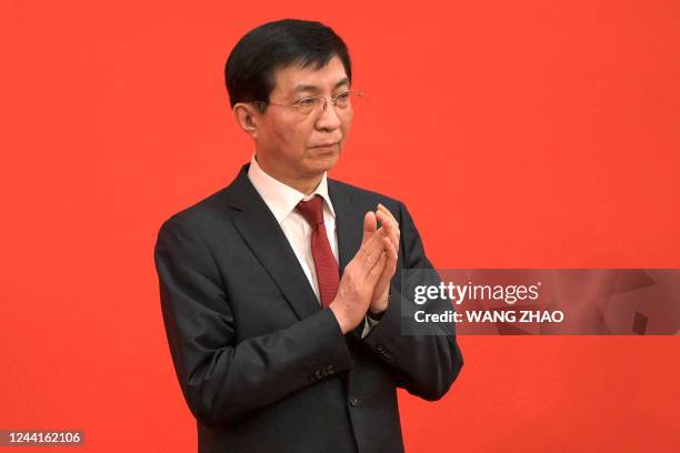 Wang Huning, current Communist Party of China's Politburo Standing Committee member, applauds as he is introduced as a member of the Communist Party...