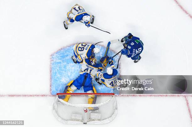 Craig Anderson of the Buffalo Sabres makes a save on Ilya Mikheyev of the Vancouver Canucks as Casey Fitzgerald Jacob Bryson and Victor Olofsson of...