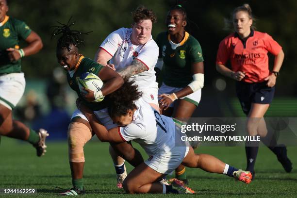 South Africa's Lusanda Dumke is tackled by England's Hannah Botterman and Tatyana Heard during the New Zealand 2021 Womens Rugby World Cup Pool C...