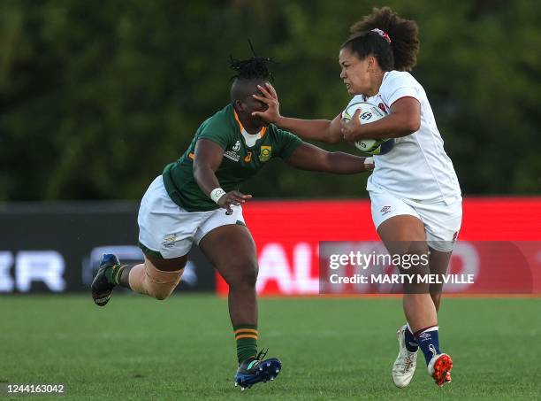 England's Tatyana Heard fends off South Africa's Lerato Makua during the New Zealand 2021 Womens Rugby World Cup Pool C match between England and...