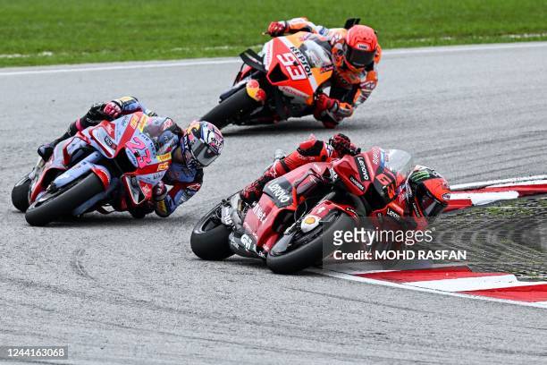 Ducati Lenovo's Italian rider Francesco Bagnaia speeds ahead of Ducati Gresini Racing's Italian rider Enea Bastianini and Repsol Honda's Spanish...