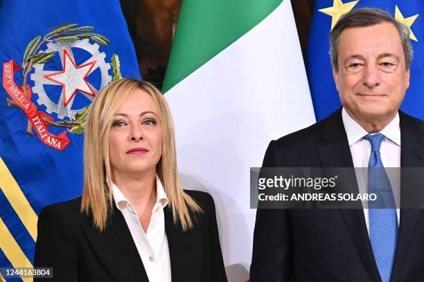 Italy's outgoing prime minister, Mario Draghi and Italy's new prime minister, Giorgia Meloni pose during a handover ceremony at Palazzo Chigi in Rome...