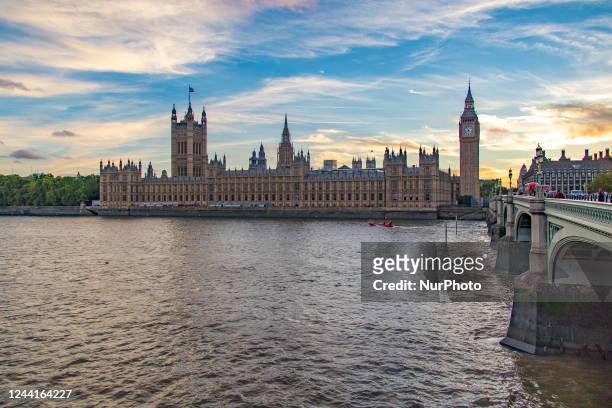 The Westminster Palace, Big Ben, the Houses of Parliament and Westminster bridge in London in a beautiful summer evening with a colorful sky after...