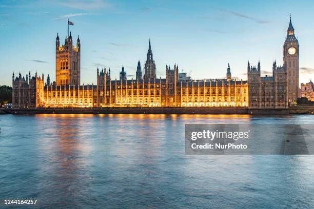 The Westminster Palace, Big Ben, the Houses of Parliament and Westminster bridge in London in a beautiful summer evening with a colorful sky after...