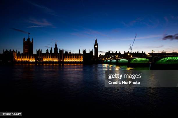 The Westminster Palace, Big Ben, the Houses of Parliament and Westminster bridge in London in a beautiful summer evening with a colorful sky after...