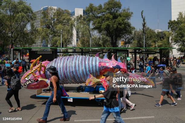 An Alebrije passes over Paseo de la Reforma during the Parade of Monumental Alebrijes. The 14th edition of the Monumental Alebrijes Parade takes...