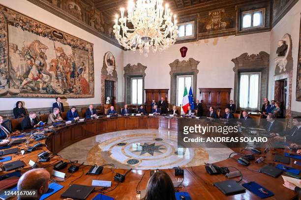 Italy's new Prime Minister, Giorgia Meloni rings the bell as she presides over her government's first Cabinet meeting on October 23, 2022 at Palazzo...