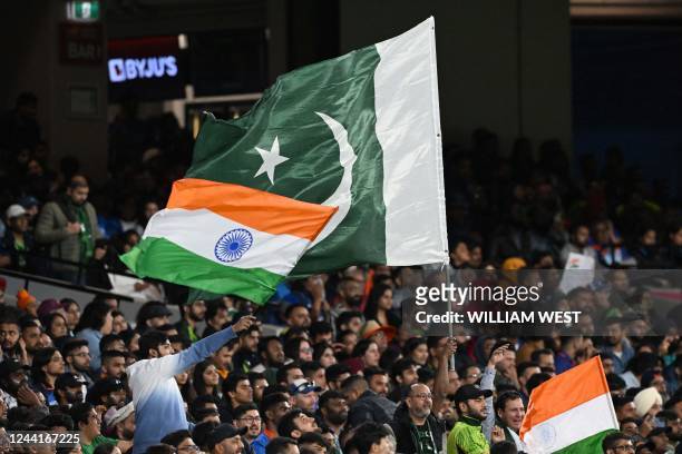 Pakistan and Indian fans wave their national flags during the ICC men's Twenty20 World Cup 2022 cricket match between India and Pakistan at Melbourne...