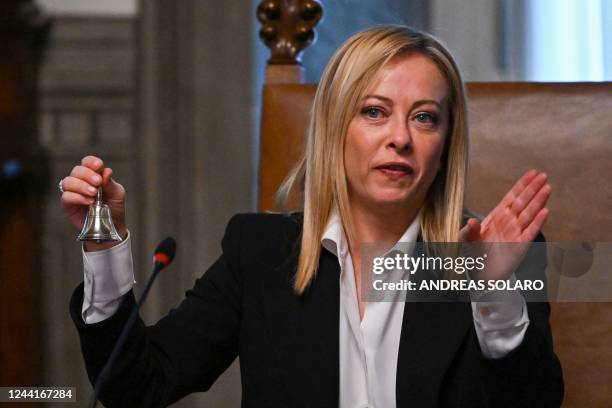 Italy's new Prime Minister, Giorgia Meloni rings the bell as she presides over her government's first Cabinet meeting on October 23, 2022 at Palazzo...