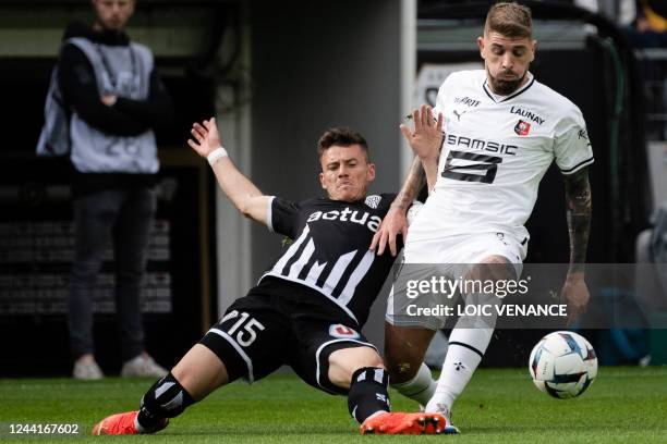 Angers' French midfielder Pierrick Capelle fights for the ball with Rennes' Portuguese midfielder Xeka during the French L1 football match between...