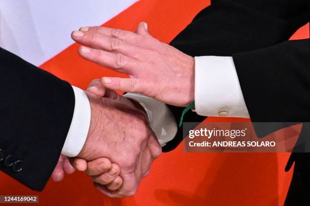 Italy's outgoing prime minister, Mario Draghi and Italy's new prime minister, Giorgia Meloni shake hands during the cabinet minister bell handover...