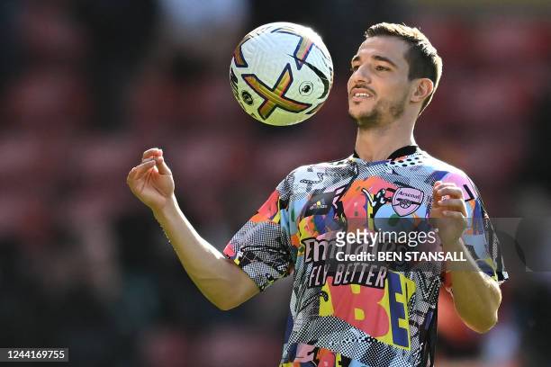 Arsenal's German-born Portuguese defender Cedric Soares warms up with teammates ahead of the English Premier League football match between...