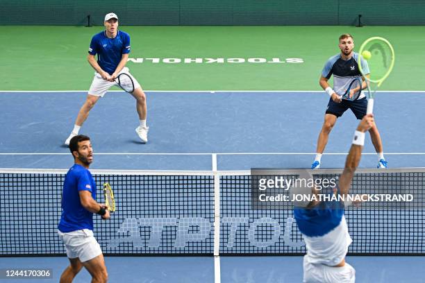 Marcelo Arevalo of El Salvador and Jean-Julien Rojer of the Netherlands return the ball to Lloyd Glasspool of Great Britain and Harri Heliovaara of...