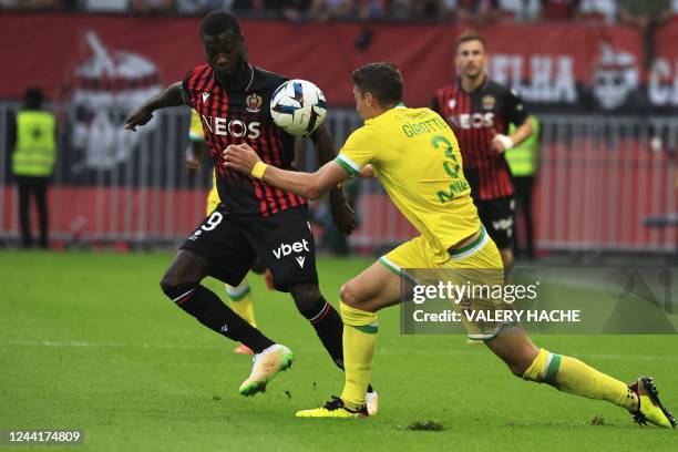 Nice's Ivorian forward Nicolas Pepe fights for the ball with Nantes' Brazilian defender Andrei Girotto during the French L1 football match between...