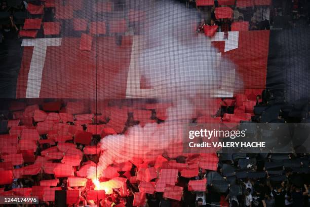 Nice supporters hold flares during the French L1 football match between OGC Nice and FC Nantes at the Allianz Riviera Stadium in Nice, south-eastern...