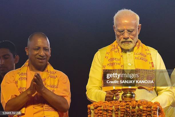 India's Prime Minister Narendra Modi inaugurates 'Deepotsav' event as the chief minister of Uttar Pradesh state Yogi Adityanath watches on the eve of...