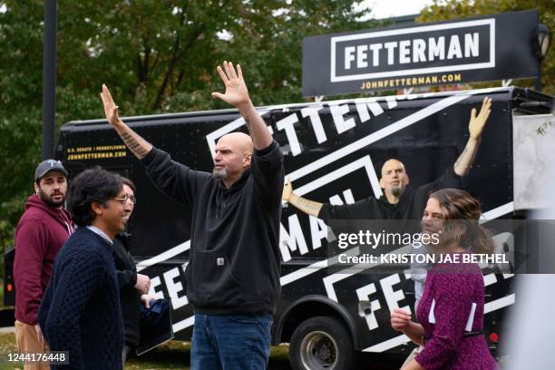 Pennsylvania's Lieutenant Governor John Fetterman waves to supporters after speaking at Dickinson Square Park in Philadelphia on October 23 as he...