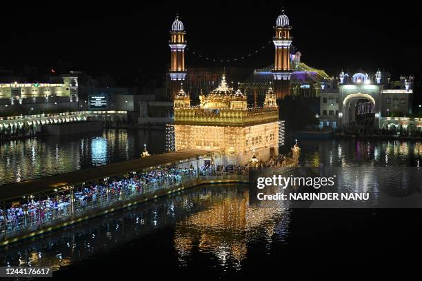 Devotees visit the illuminated Golden Temple on the eve of 'Bandi Chhor Divas', a Sikh festival coinciding with Diwali, the Hindu festival of lights,...