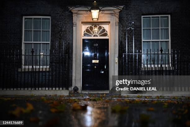 An light illuminates the door to 10 Downing Street, the official residence of Britain's Prime Minister in central London on October 23, 2022. -...