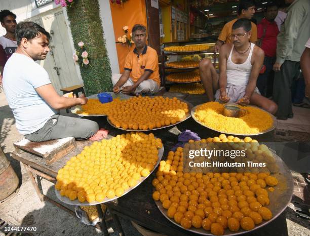 Workers prepare Laddoo near Patna Museum on the ve of Diwali, on October 23, 2022 in Patna, India.