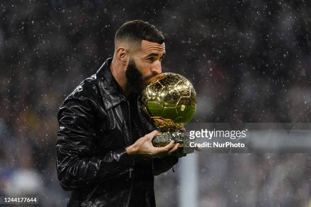 Karim Benzema of Real Madrid Cf offers the fans the Golden Ball at the Santiago Bernabéuduring a match between Real Madrid v Sevilla FC as part of...