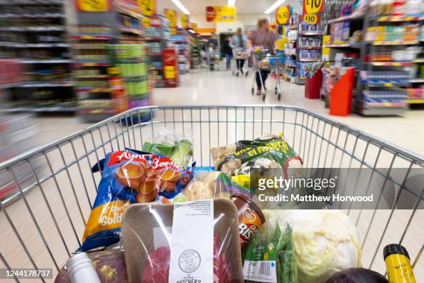 In this photo illustration, a trolly of shopping filled with produce used in a traditional Sunday roast dinner is seen on October 23, 2022 in...