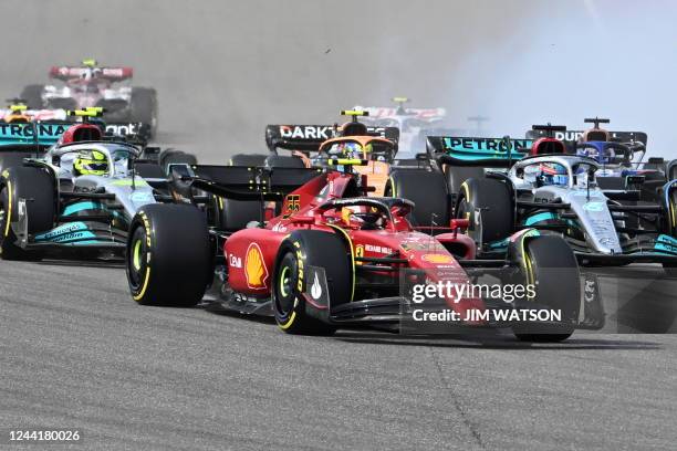 Ferrari's Spanish driver Carlos Sainz Jr. , races at the start ofthe Formula One United States Grand Prix, just before a collision with Mercedes'...
