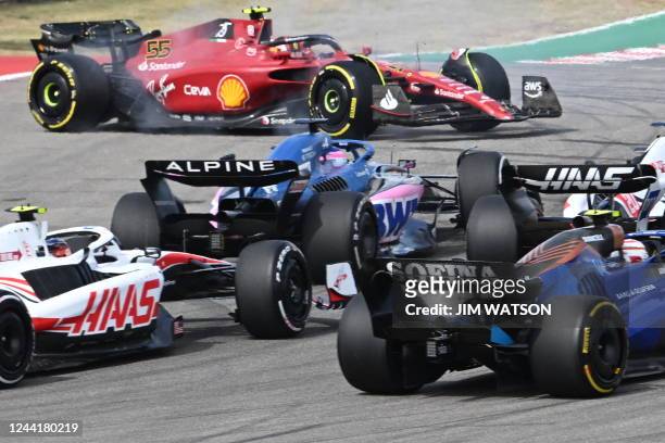 Ferrari's Spanish driver Carlos Sainz Jr. , spins out at the start of the Formula One United States Grand Prix, after a collision with Mercedes'...
