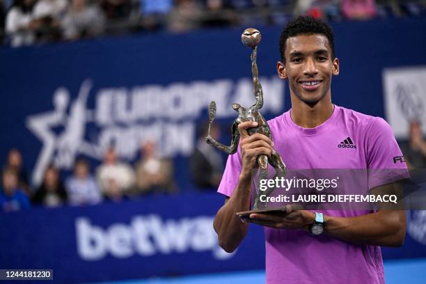 Canadian Felix Auger-Aliassime celebrates with his trophy after winning the men's singles final match between Canadian Auger-Aliassime and American...