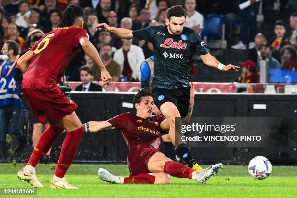 Roma's Italian midfielder Nicolo Zaniolo tackles Napoli's Georgian forward Khvicha Kvaratskhelia during the Italian Serie A football match between AS...