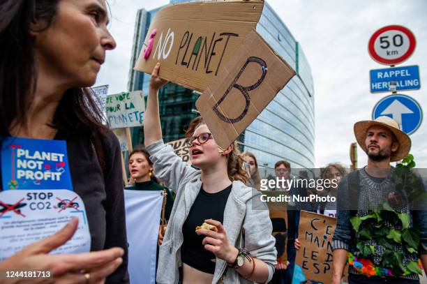 People are shouting slogans against climate change, during a massive climate demonstration organized in Brussels, on October 23rd, 2022.
