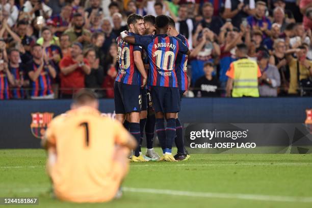 Barcelona's Spanish forward Ferran Torres celebrates scoring his team's fourth goal with teammates during the Spanish league football match between...