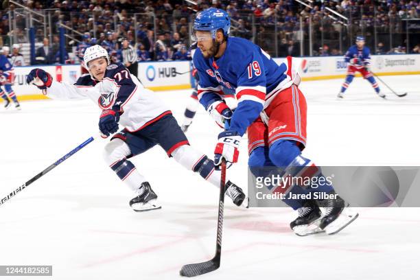 Andre Miller of the New York Rangers skates with the puck against Nick Blankenburg of the Columbus Blue Jackets at Madison Square Garden on October...