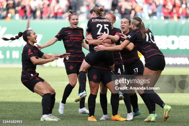 Meghan Klingenberg of Portland Thorns FC jumps into the arms of Raquel Rodríguez after Rodriguez scored a goal during the first half of the NWSL...