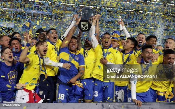 Players of Boca Juniors celebrate with the trophy after winning the Argentine Professional Football League tournament, after tying 2-2 with...